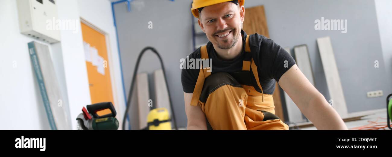 Man builder holds laminate board in his hands Stock Photo