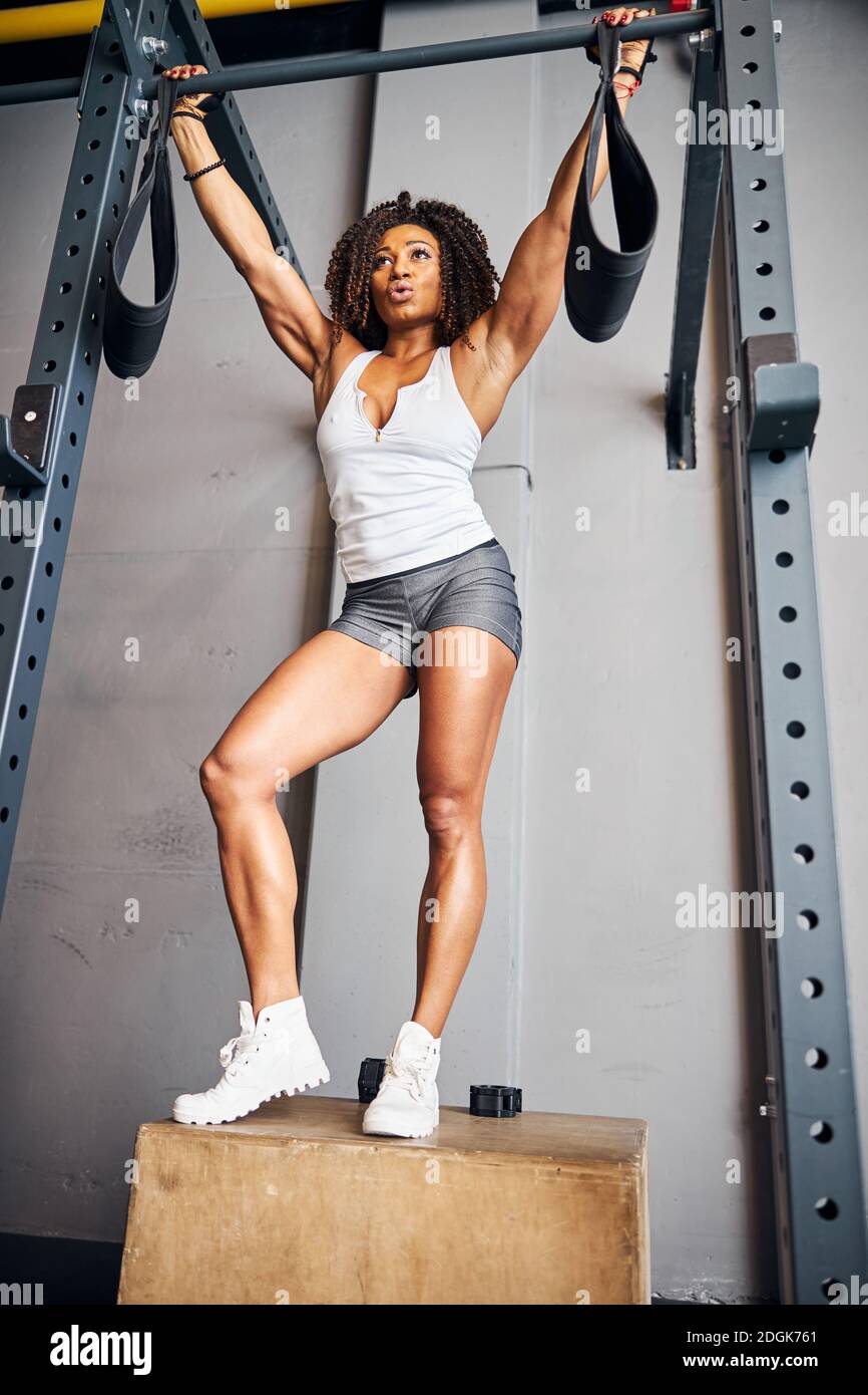 Fit woman preparing for the pull-ups on the horizontal bar Stock Photo -  Alamy