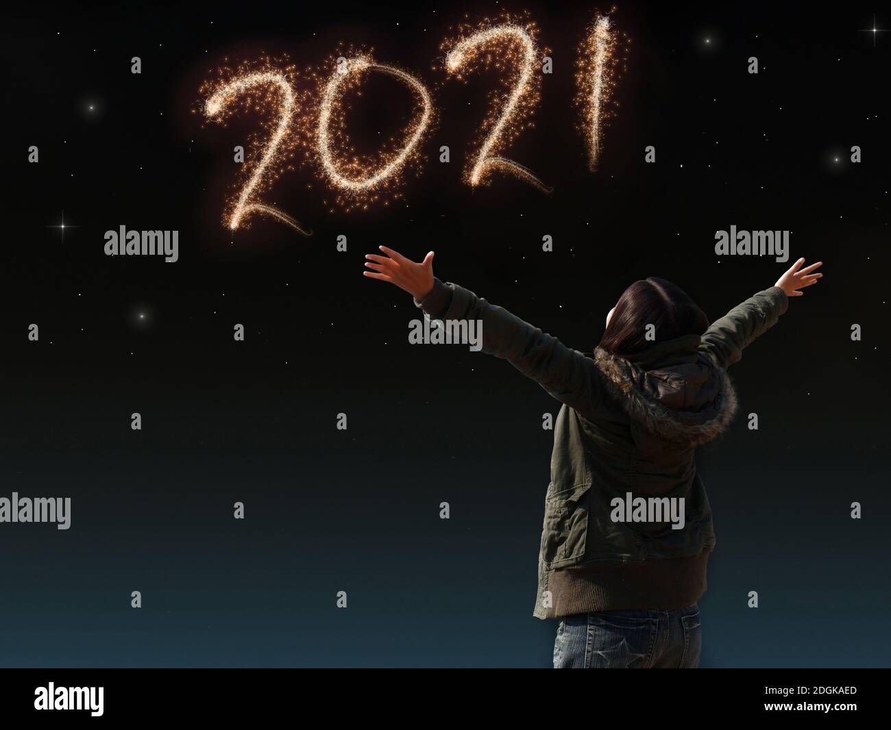 happy Asian girl open arm with joyful on countdown night with firework light for 2021 year. image of happy new year celebration party Stock Photo