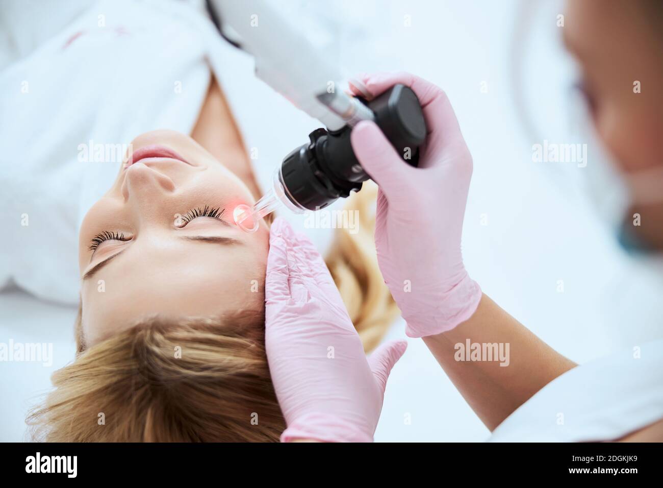 Professional woman dermatologist doing a beauty procedure Stock Photo