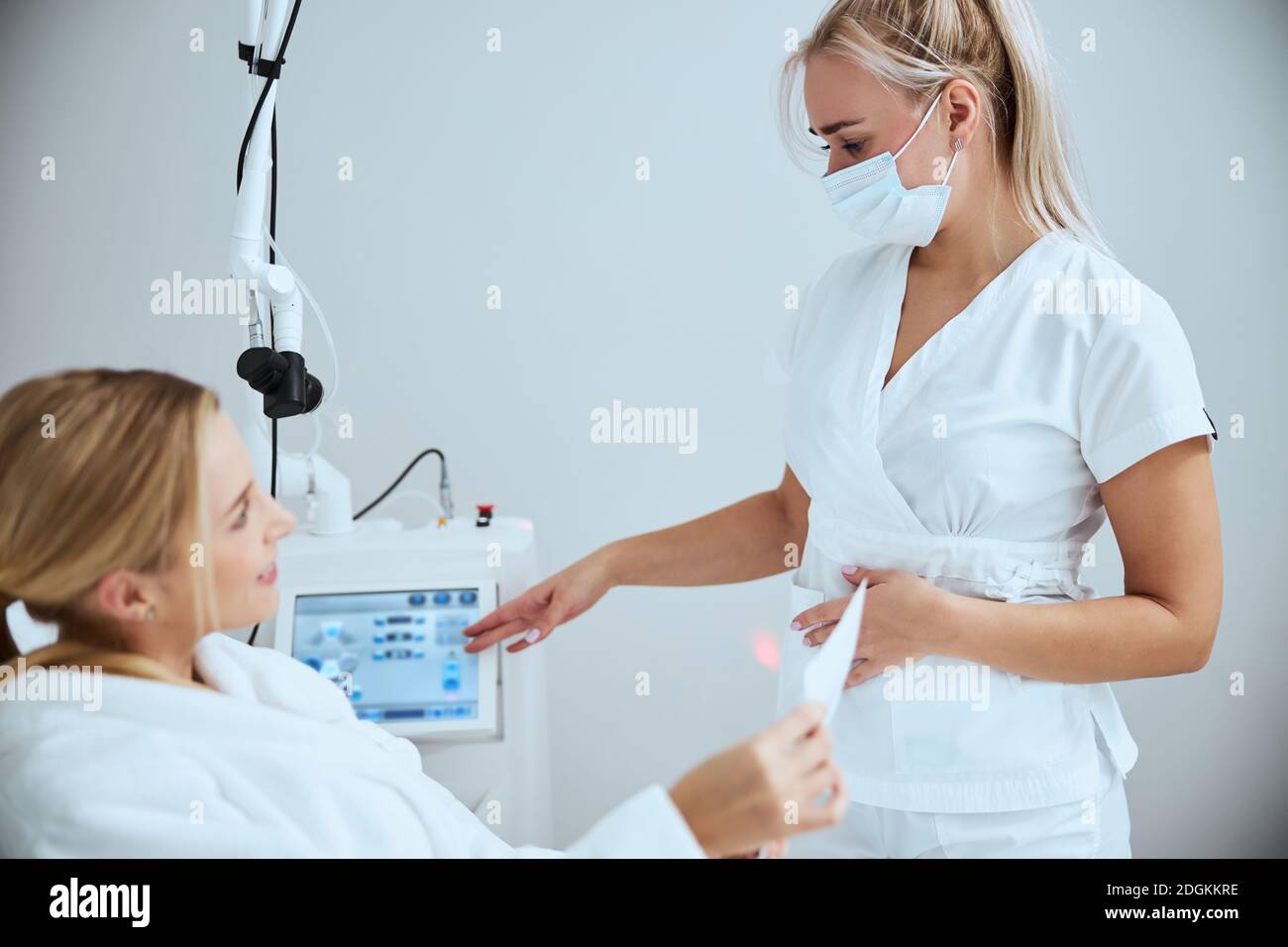 Cosmetologist and her client discussing an upcoming beauty procedure Stock Photo