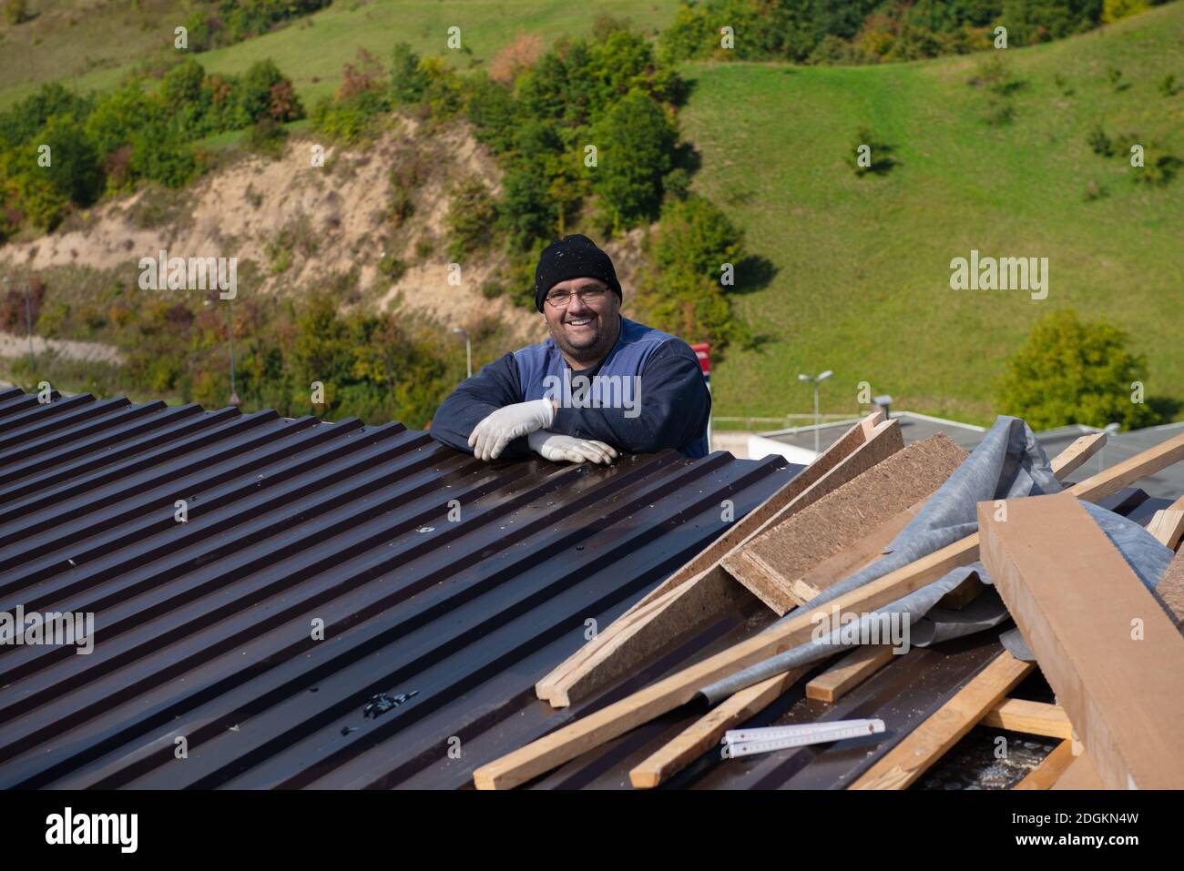 Construction worker installing a new roof Stock Photo