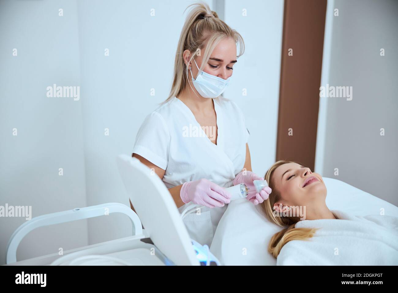 Focused dermatologist preparing for treating her patient Stock Photo