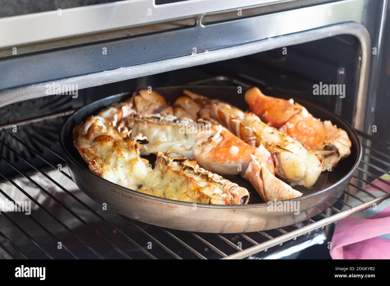 To remove the grilled lobster from the oven Stock Photo Alamy