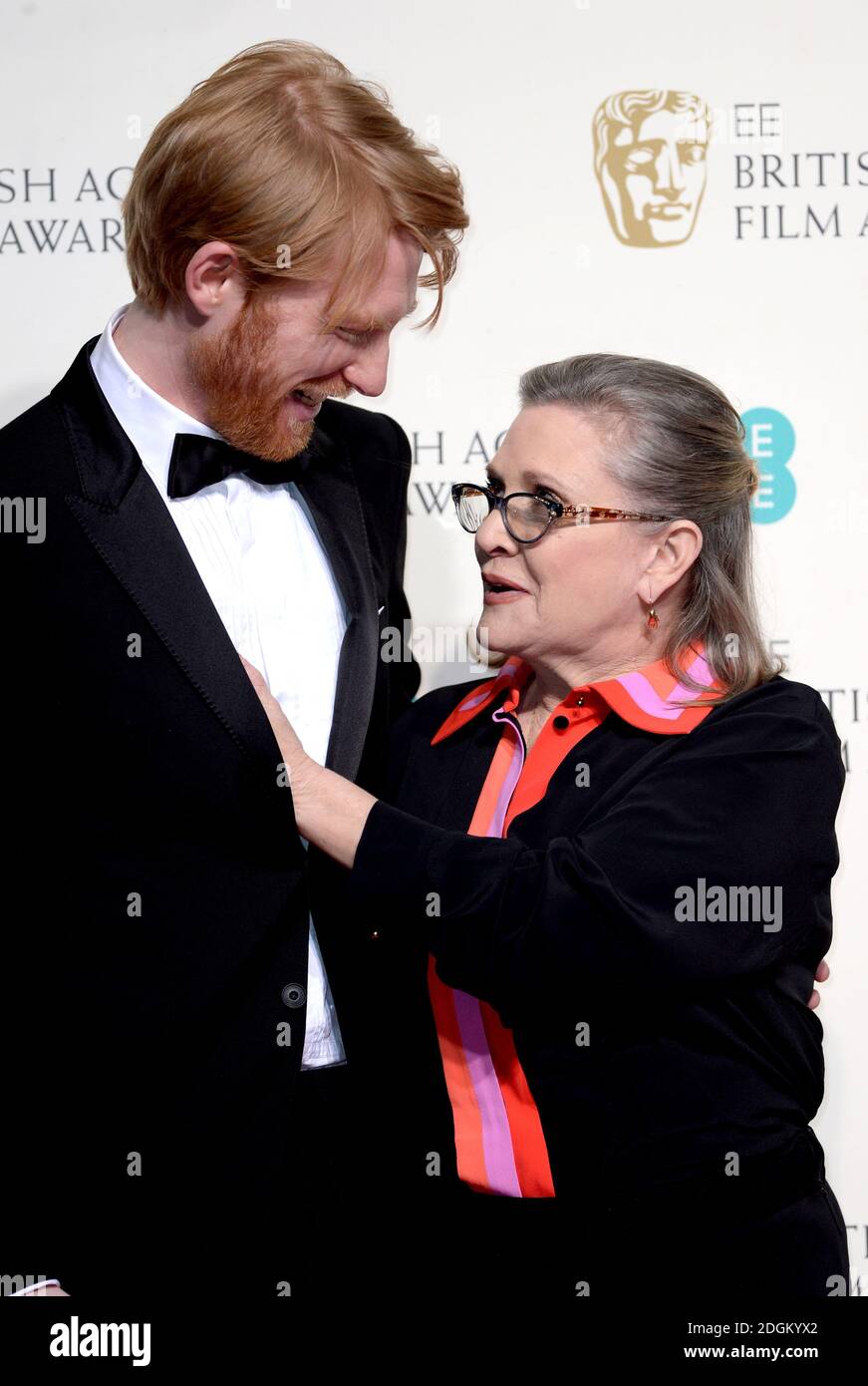 Domhnall Gleeson and Carrie Fisher in the press room during the EE British Academy Film Awards at the Royal Opera House, Bow Street, London.  EMPICS Entertainment Photo. Picture date: Sunday February 14, 2016. Photo credit should read: Doug Peters/ EMPICS Entertainment Stock Photo