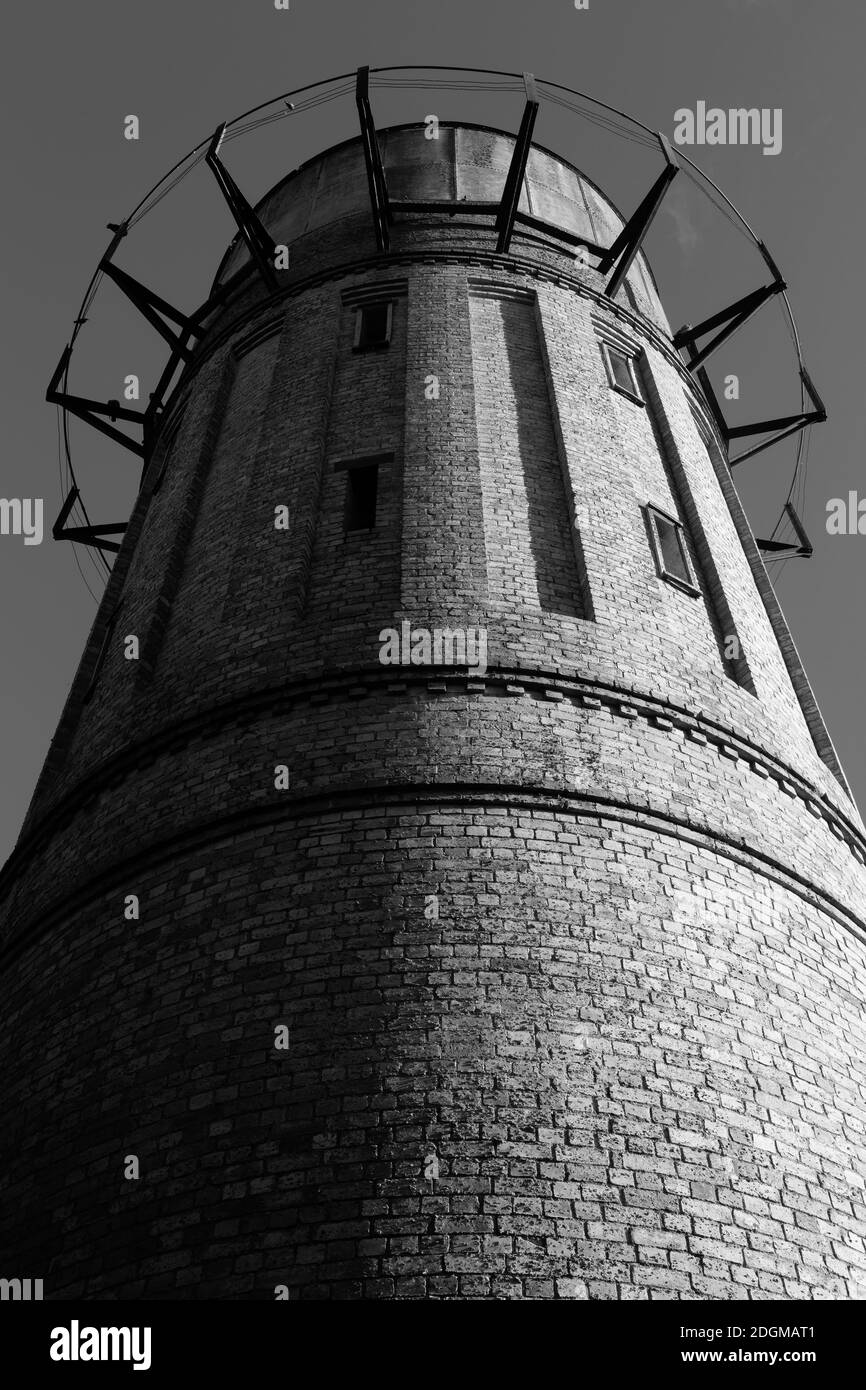 An old brick water tower, built in the early 20th century. Black and white. Cambridge, New Zealand Stock Photo