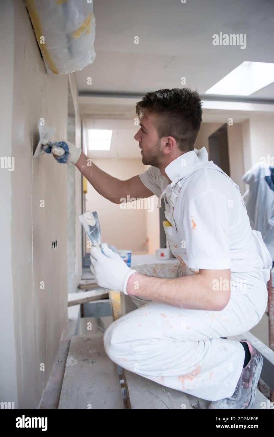 Construction worker plastering on gypsum walls Stock Photo