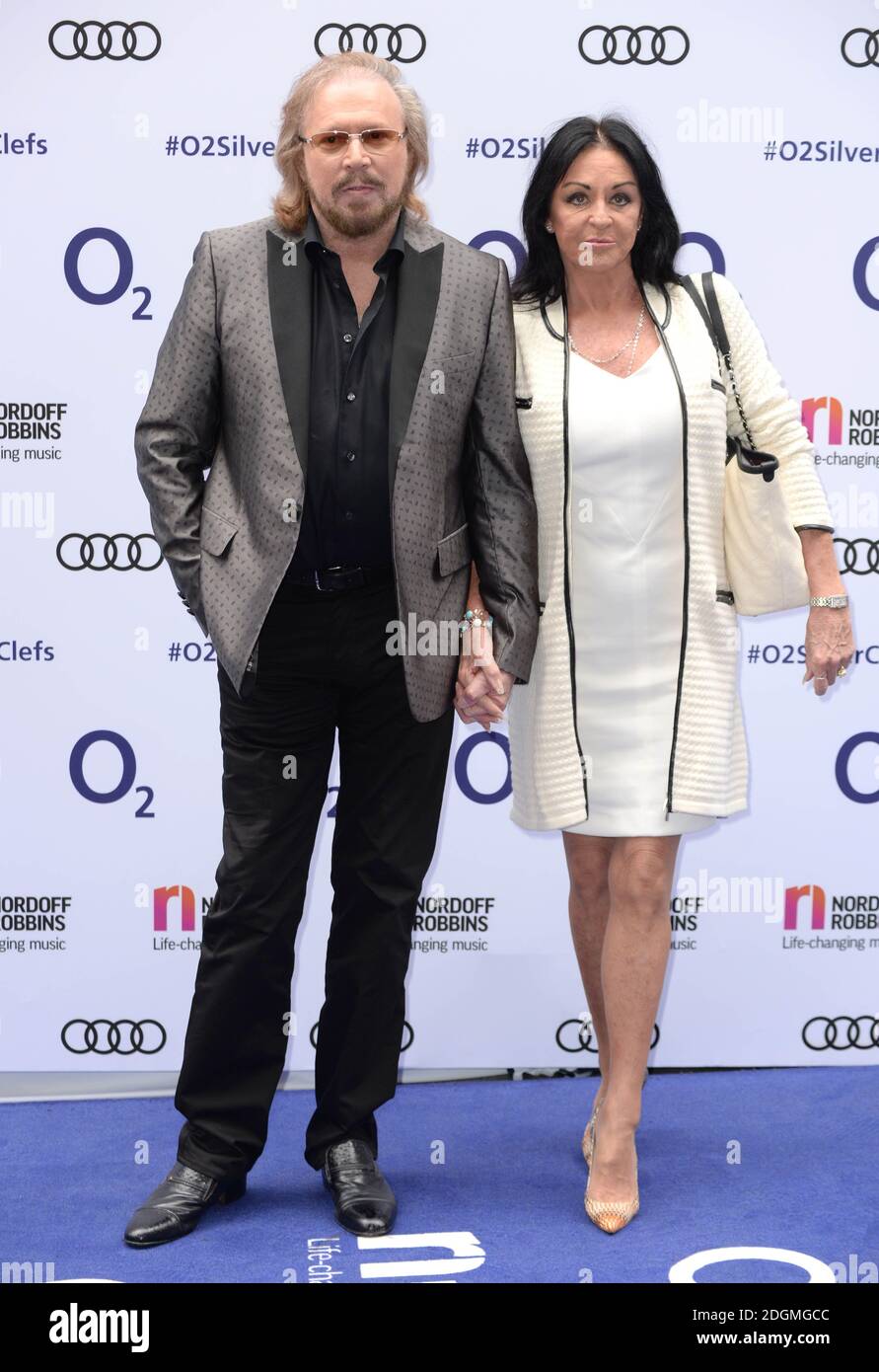 Barry Gibb and Linda Gray attending the O2 Silver Clef Awards, in association with Nordoff Robbins, at Grosvenor House Hotel in London.   Photo credit should read Doug Peters/ EMPICS Entertainment  Stock Photo
