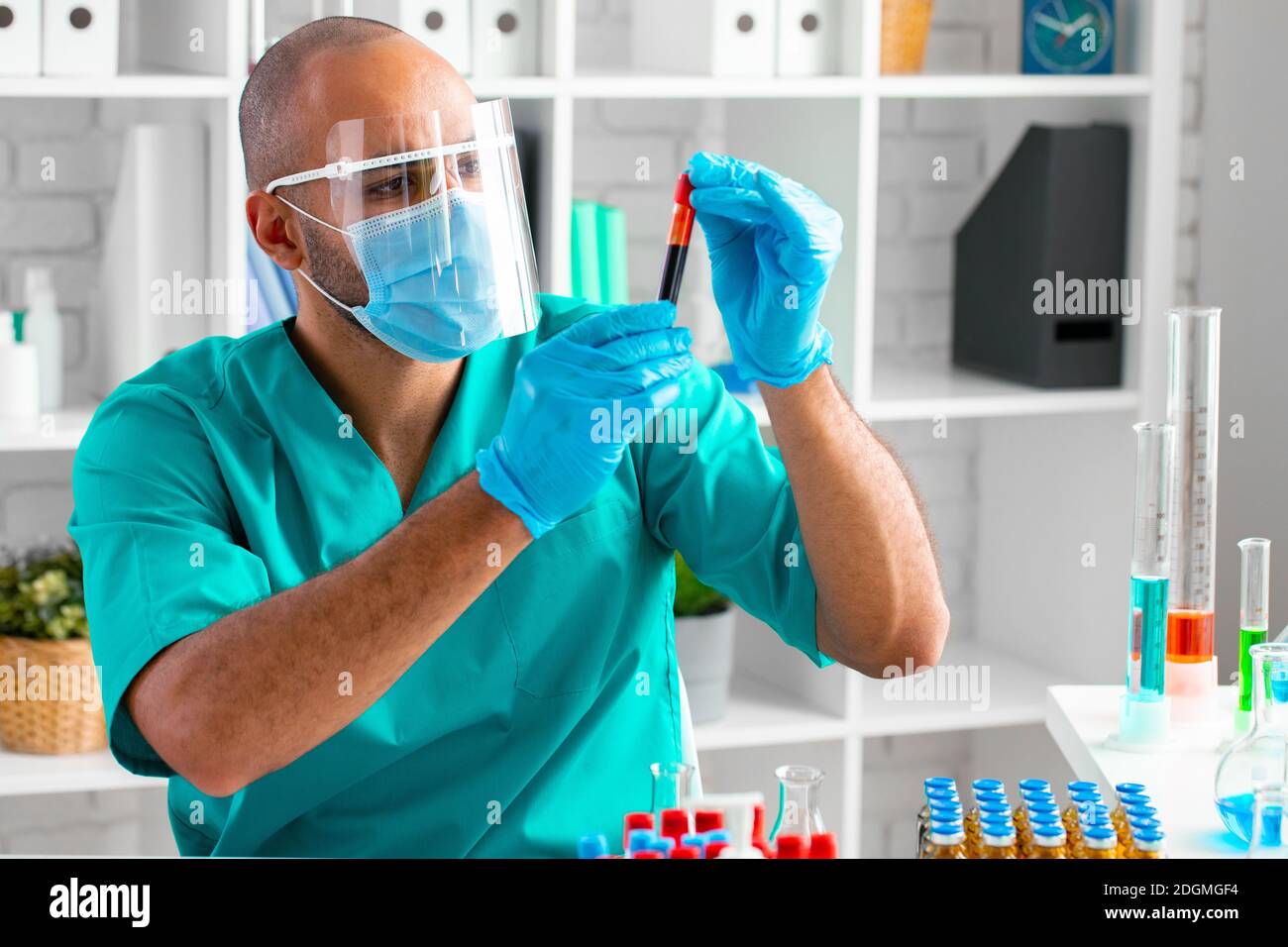 African american doctor or laboratory worker examines blood sample in ...
