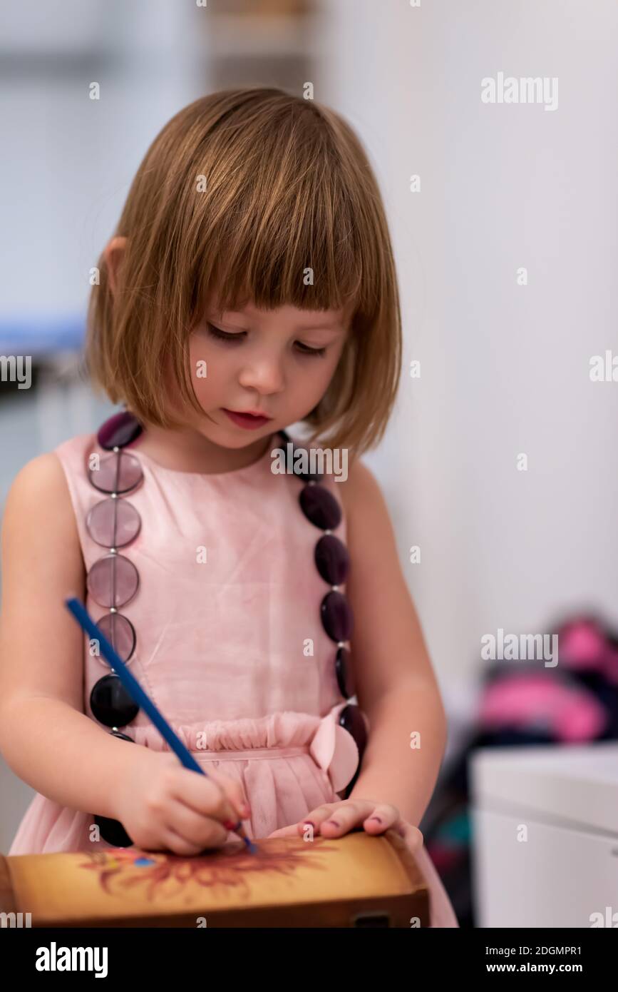 Little girl painting jewelry box Stock Photo - Alamy