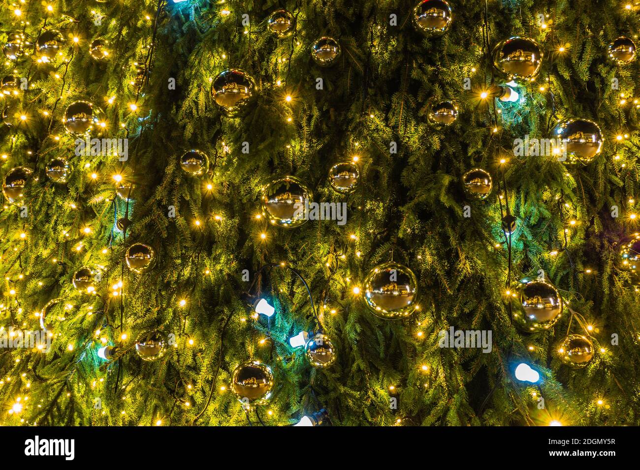Green Christmas Tree with Decorations and Lights Stock Photo