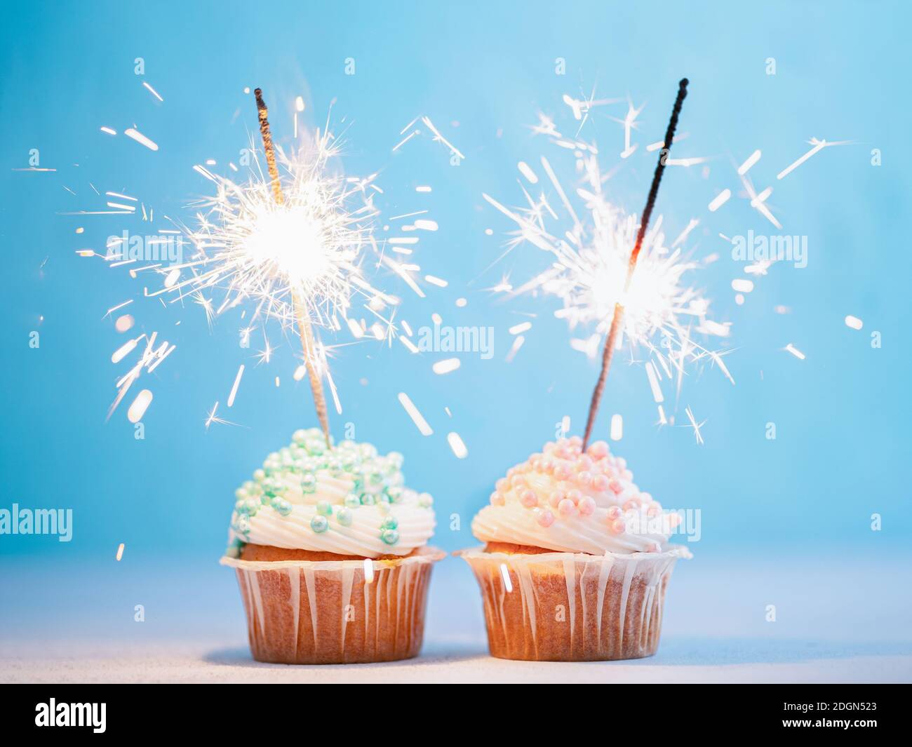 Two cupcakes decorated with sparklers Stock Photo