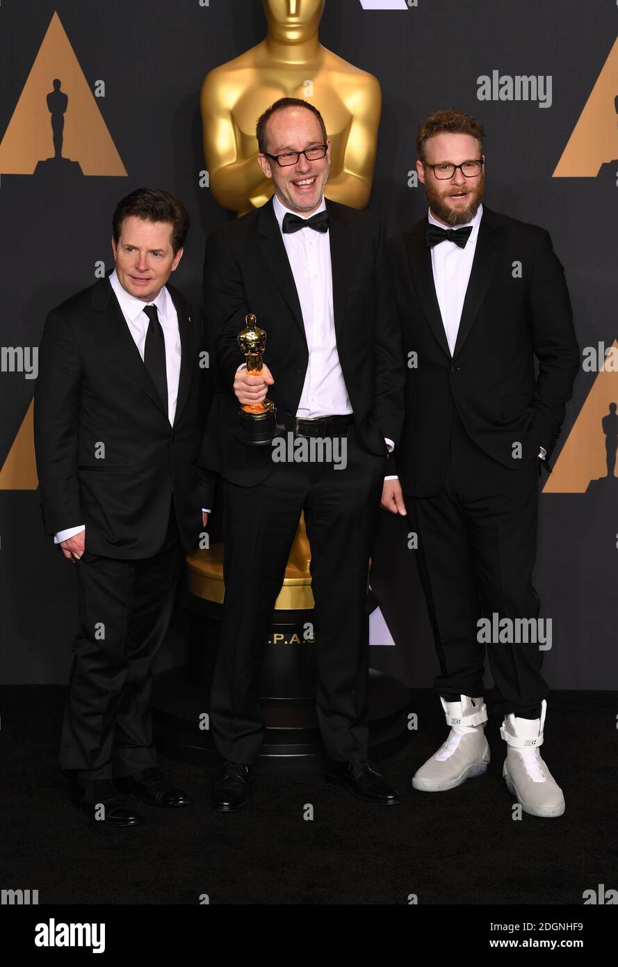 Michael J. Fox, editor John Gilbert, winner of Best Film Editing for  'Hacksaw Ridge' and actor Seth Rogen in the press room of the 89th Academy  Awards held at the Dolby Theatre