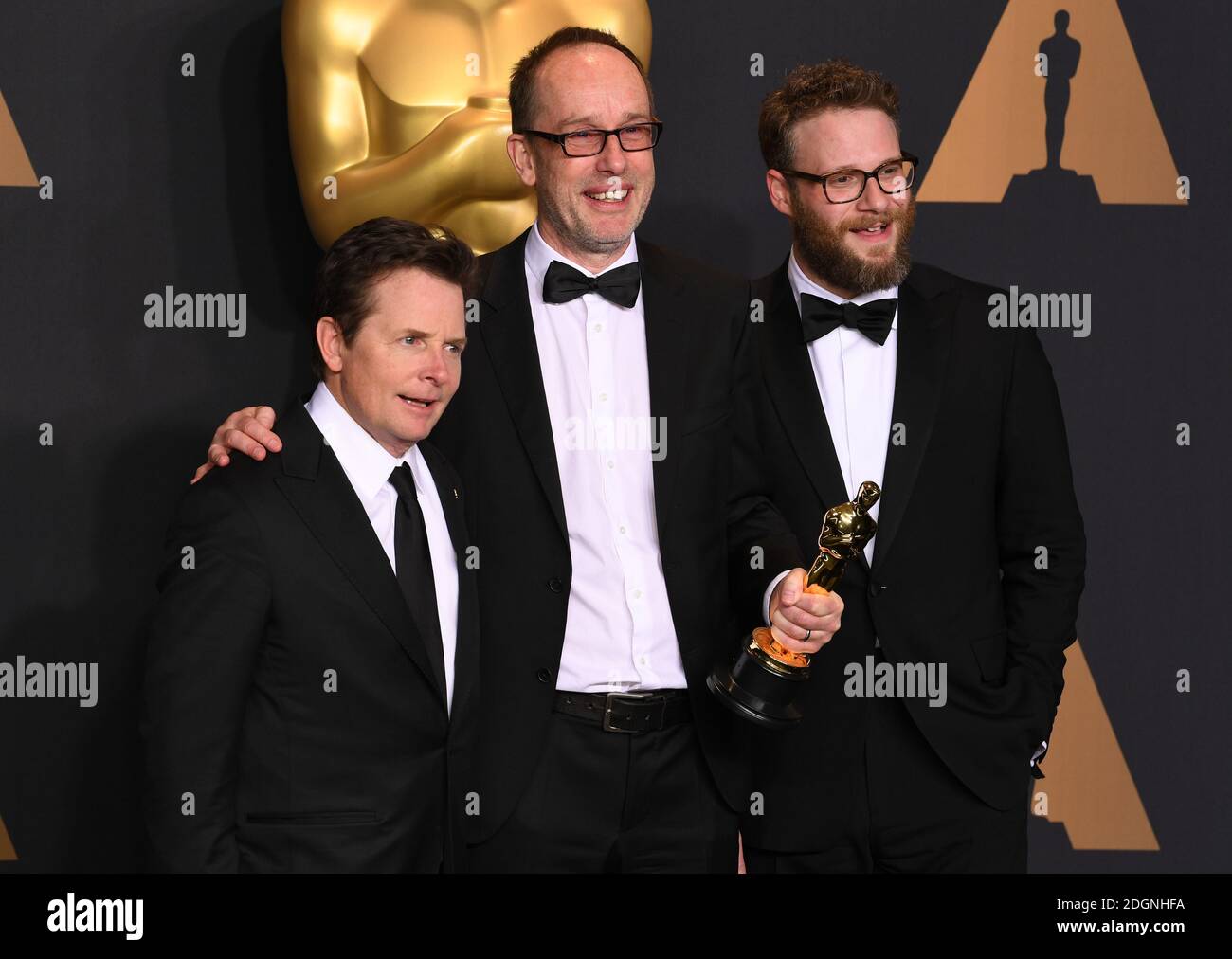 Michael J. Fox, editor John Gilbert, winner of Best Film Editing for 'Hacksaw Ridge' and actor Seth Rogen in the press room of the 89th Academy Awards held at the Dolby Theatre in Hollywood, Los Angeles, CA, USA.  Picture date Sunday February 26, 2017. Picture credit should read Doug Peters/ EMPICS Entertainment.  Stock Photo