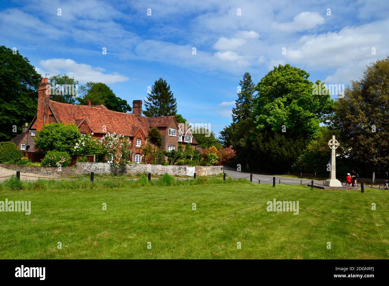 View of cottages and a celtic cross war memorial, on the village green at Lee Common, Buckinghamshire, UK Stock Photo