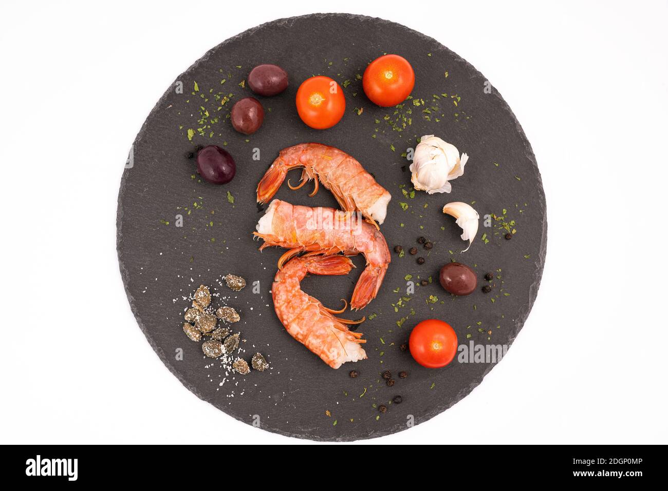 the ingredients to prepare the prawns on a stone surface Stock Photo