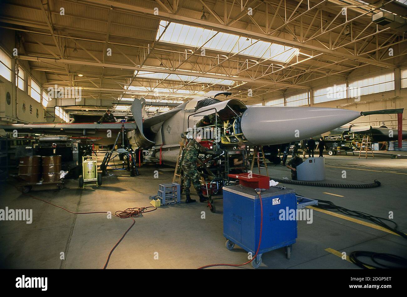 RAF Upper Heyford airbase Oxfordshire UK 1990. Home of 20th Tactical Fighter wing USAF. Ground crew technicians working on  F111 Aardvark's in a base hanger.. Stock Photo