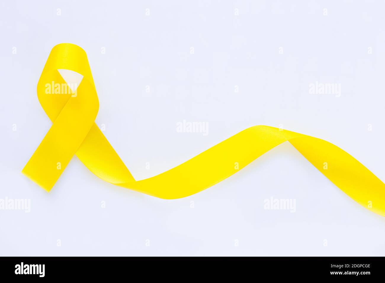 Yellow ribbon on white isolated background, copy space. Bone cancer, Sarcoma Awareness, childhood cancer awareness, cholangiocarcinoma, gallbladder ca Stock Photo