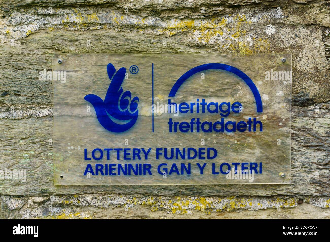 Heritage lottery fund sign on an ancient monument in English and Welsh language the fund support heritage projects in the UK Stock Photo