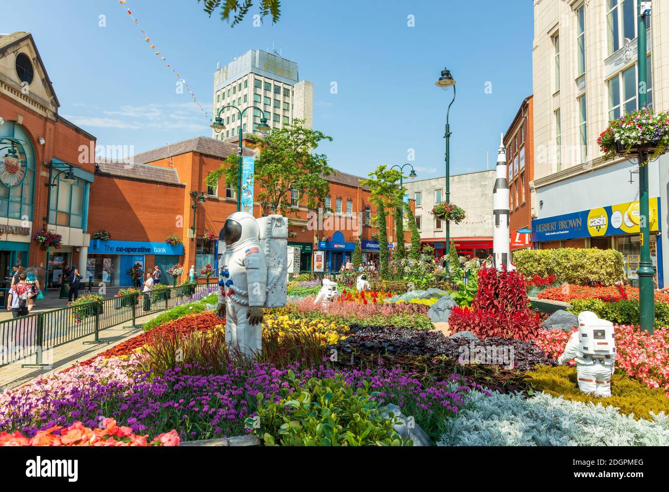 Alien landscape with American astronauts landing on the Moon theme community garden in the middle of town, UK. Stock Photo