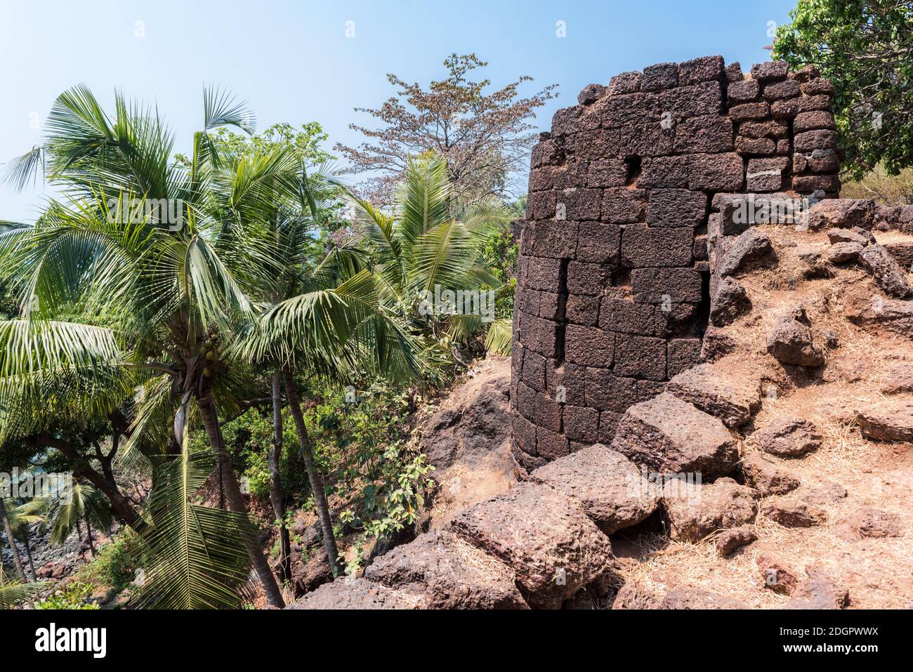 View of the old stone tower of the Portuguese fortress Fort Cabo De Rama in the rainforest in Goa, India Stock Photo