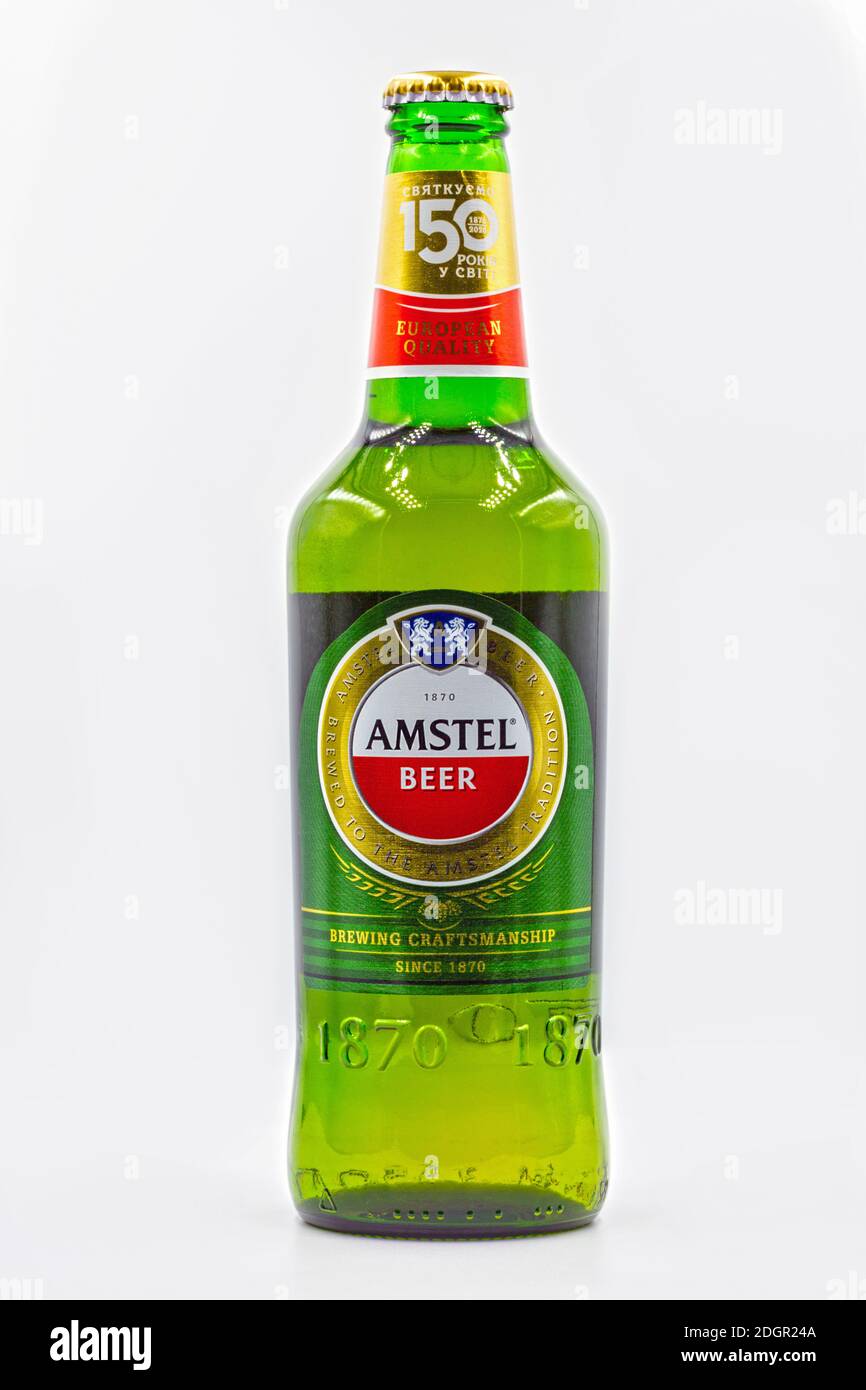 KYIV, UKRAINE - SEPTEMBER 14, 2020: Amstel beer bottle closeup against white background. Amstel is a Dutch brewery founded 1870 in Amsterdam. It was t Stock Photo