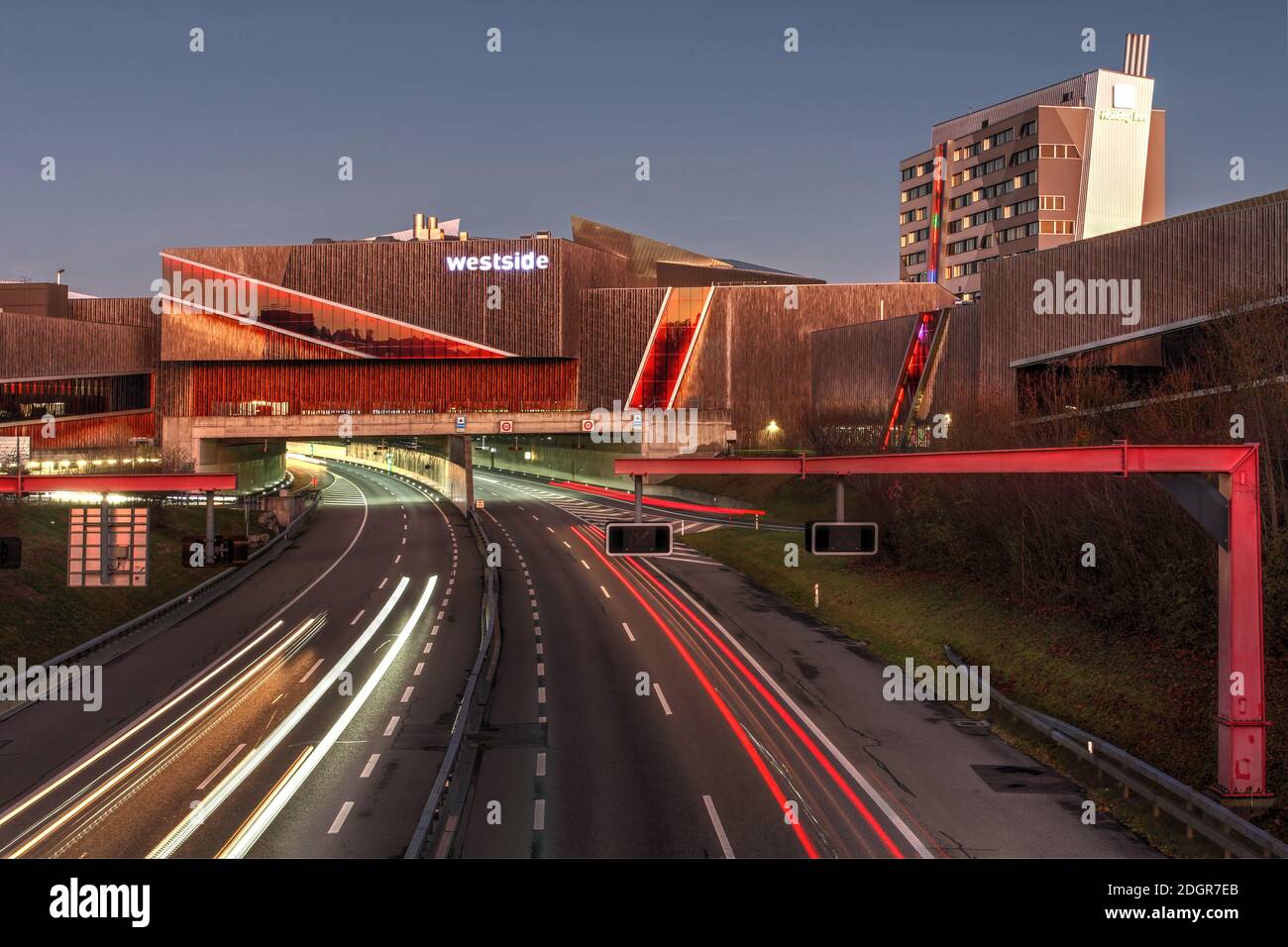 Bern, Switzerland - November 21, 2020 - Westside Shopping and Leisure Centre at night with traffic on A1 motorway going under the development before e Stock Photo