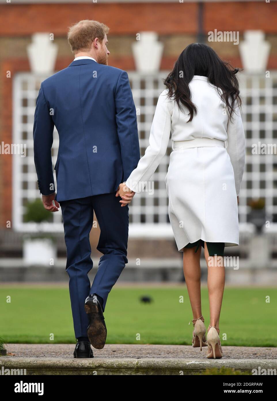 Prince Harry and Meghan Markle at a photocall to announce their engagement at Kensington Palace, London. Photo credit should read: Doug Peters/EMPICS Entertainment Stock Photo
