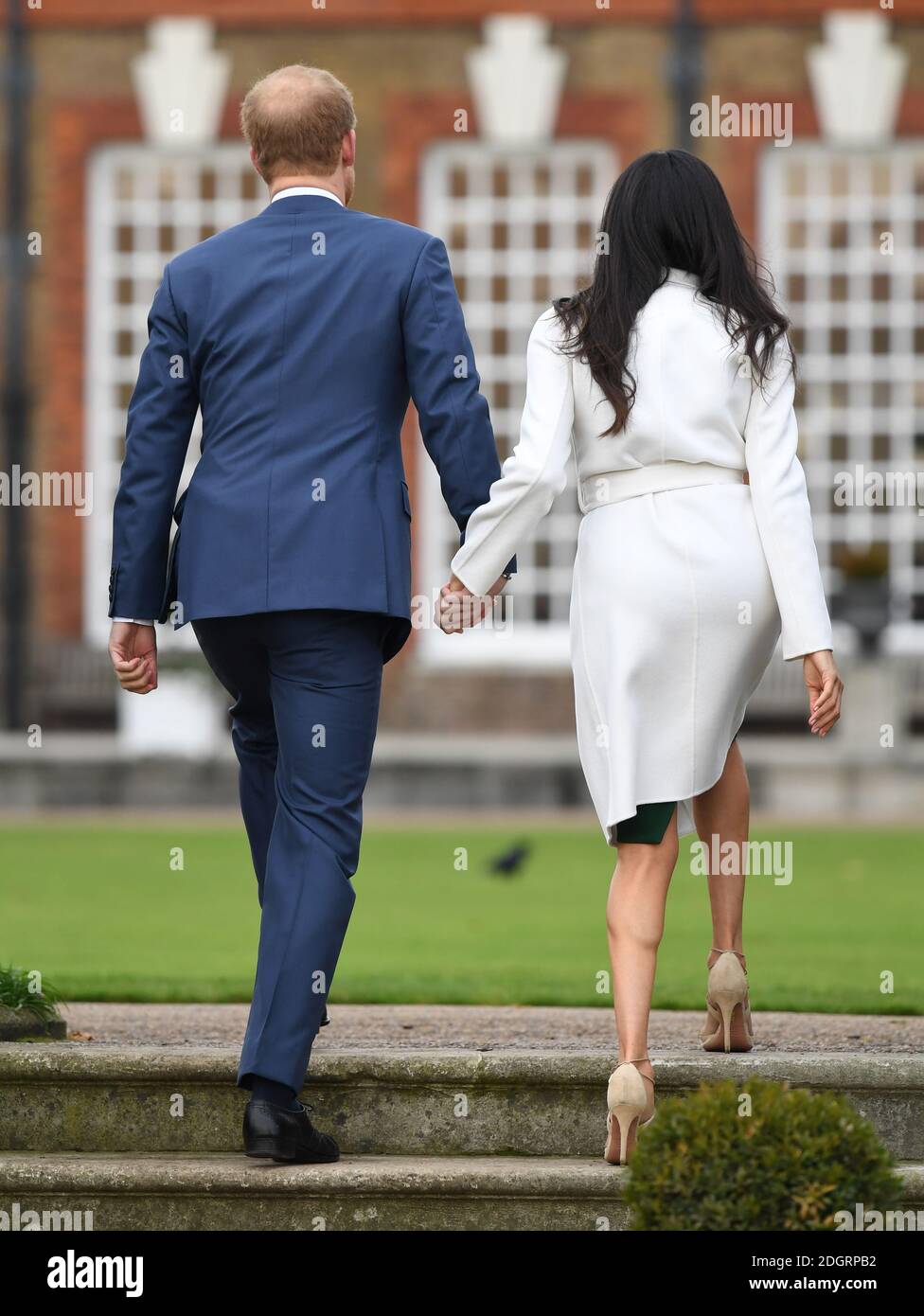 Prince Harry and Meghan Markle at a photocall to announce their engagement at Kensington Palace, London. Photo credit should read: Doug Peters/EMPICS Entertainment Stock Photo