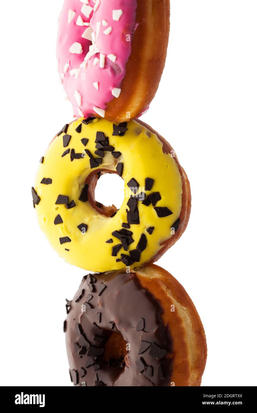 Stack of assortment of colorful donuts isolated on white background ...