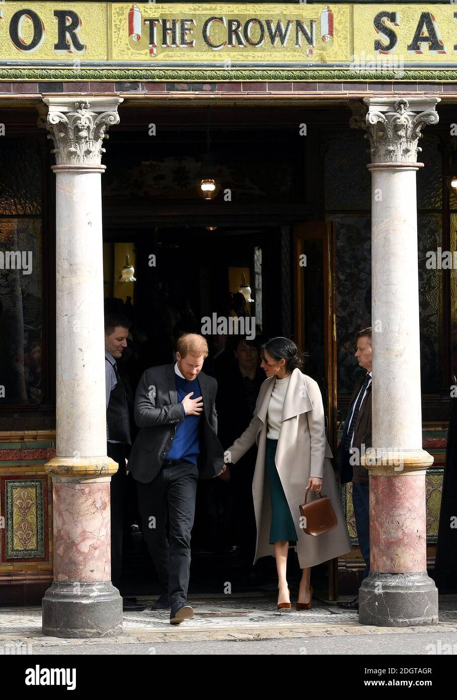 Prince Harry and Meghan Markle leave the Crown Liquor Saloon Bar after visiting before a walkabout in the city centre Stock Photo
