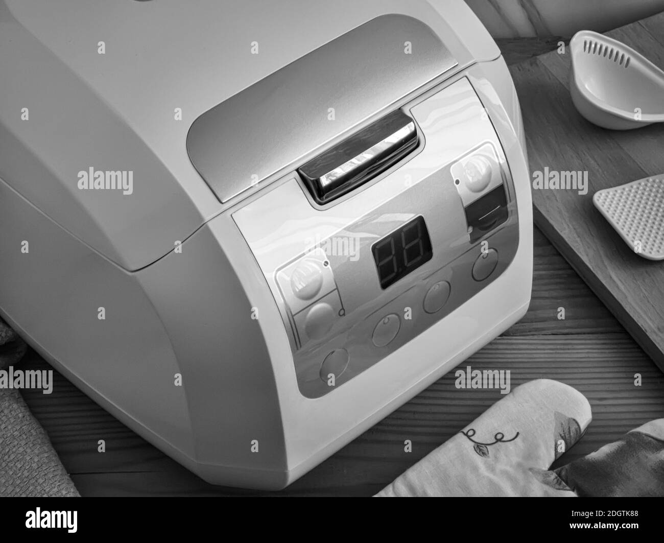 Modern electric multicooker and a set of kitchen accessories Stock