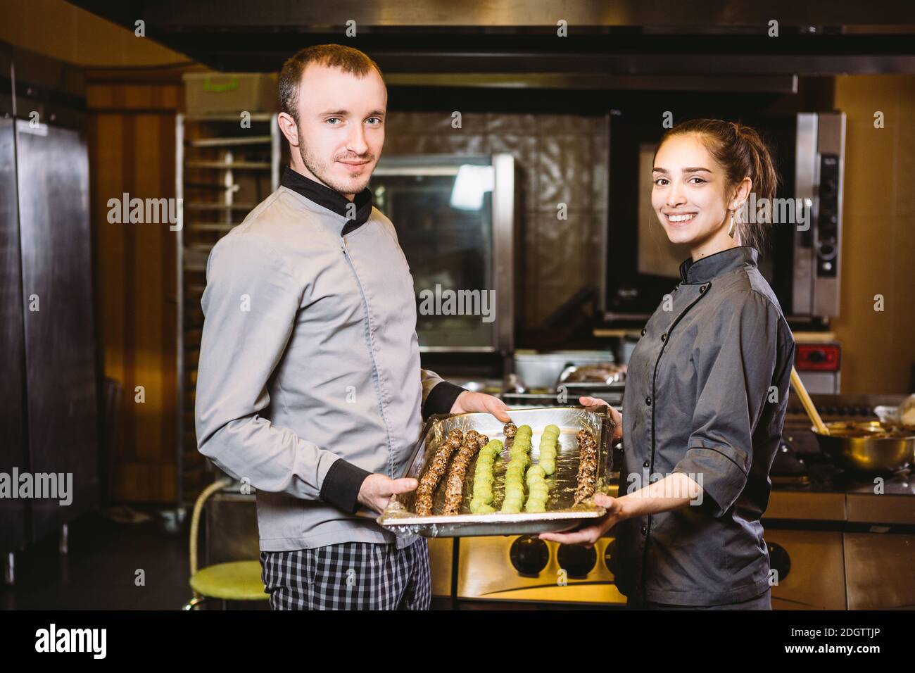 Profession preparation confectionery products. Caucasian man and woman ...