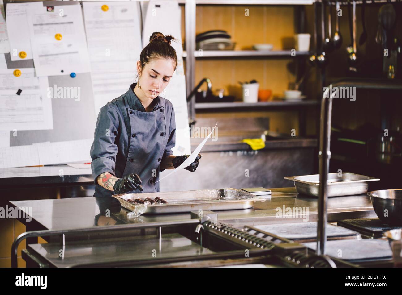 Subject profession and cooking pastry. young Caucasian woman with tattoo of pastry chef in kitchen of restaurant preparing round Stock Photo - Alamy Subject profession and cooking pastry. young Caucasian woman with tattoo of pastry chef in kitchen of restaurant preparing round Stock Photo - Alamy