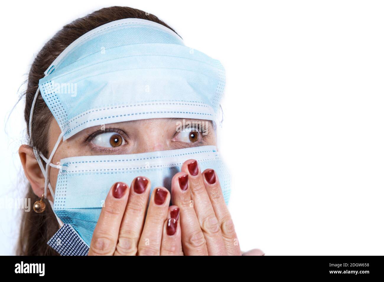 Fear of young woman in a lot of masks close up. isolated on a white. Stock Photo