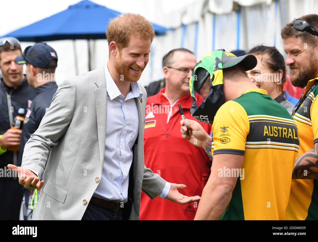 Prince Harry Duke of Sussex meets athletes at  the Invictus Games and joined a medal presentation. He was presented with a pair of Budgie Smuggler swimming trunks by the Australian athletes. The Duchess of Sussex who was due to be there pulled out of the event due to be tired and needing rest ahead of the rest of the Royal Tour, the Botanic Gardens, Sydney. Photo credit should read: Doug Peters/EMPICS Stock Photo