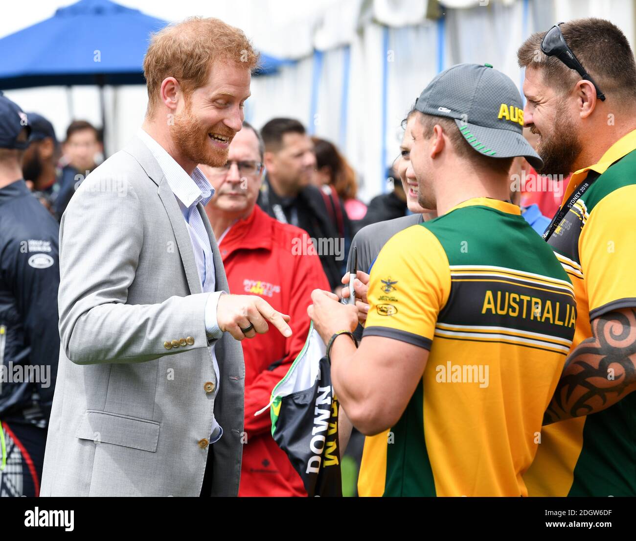 Prince Harry Duke of Sussex meets athletes at  the Invictus Games and joined a medal presentation. He was presented with a pair of Budgie Smuggler swimming trunks by the Australian athletes. The Duchess of Sussex who was due to be there pulled out of the event due to be tired and needing rest ahead of the rest of the Royal Tour, the Botanic Gardens, Sydney. Photo credit should read: Doug Peters/EMPICS Stock Photo