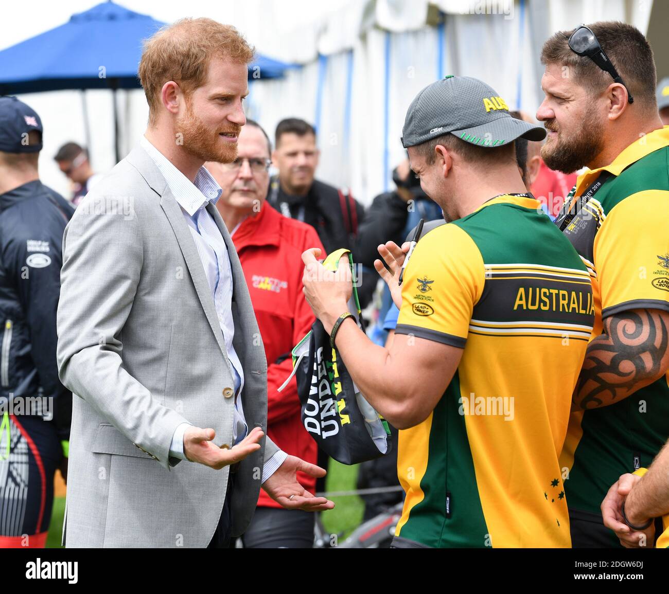 Prince Harry Duke of Sussex meets athletes at  the Invictus Games and joined a medal presentation. He was presented with a pair of Budgie Smuggler swimming trunks by the Australian athletes. The Duchess of Sussex who was due to be there pulled out of the event due to be tired and needing rest ahead of the rest of the Royal Tour, the Botanic Gardens, Sydney. Photo credit should read: Doug Peters/EMPICS Stock Photo