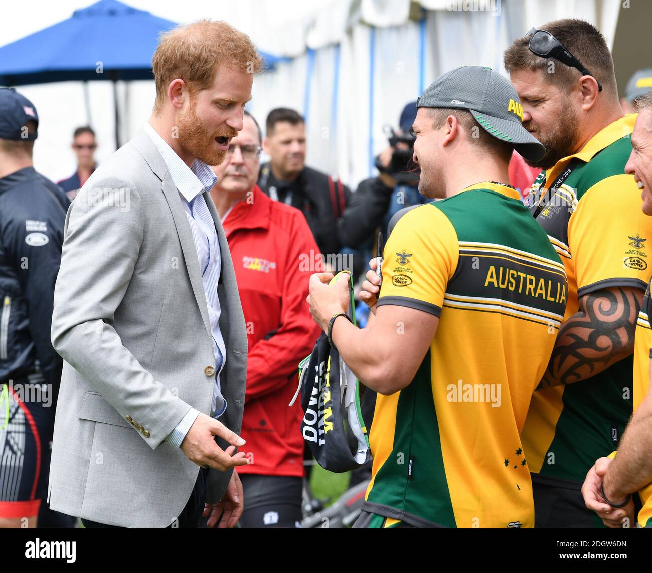 Prince Harry Duke of Sussex meets athletes at  the Invictus Games and joined a medal presentation. He was presented with a pair of Budgie Smuggler swimming trunks by the Australian athletes. The Duchess of Sussex who was due to be there pulled out of the event due to be tired and needing rest ahead of the rest of the Royal Tour, the Botanic Gardens, Sydney. Photo credit should read: Doug Peters/EMPICS Stock Photo