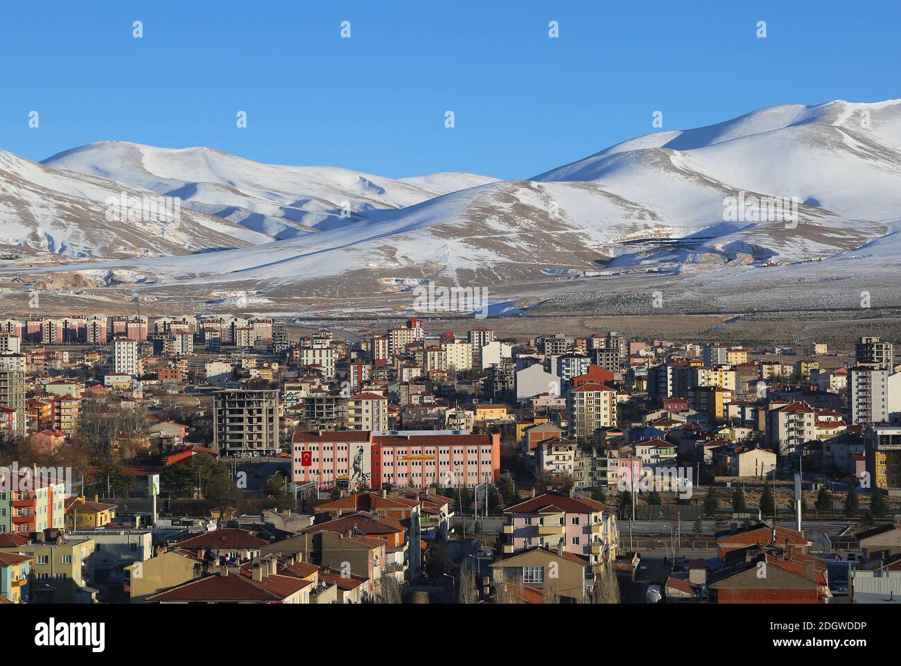 NIGDE,TURKEY-JANUARY 15:Snowy Hills,High School,Businesses and Apartment Buildings.January 15,2017 in Nigde,Turkey. Stock Photo