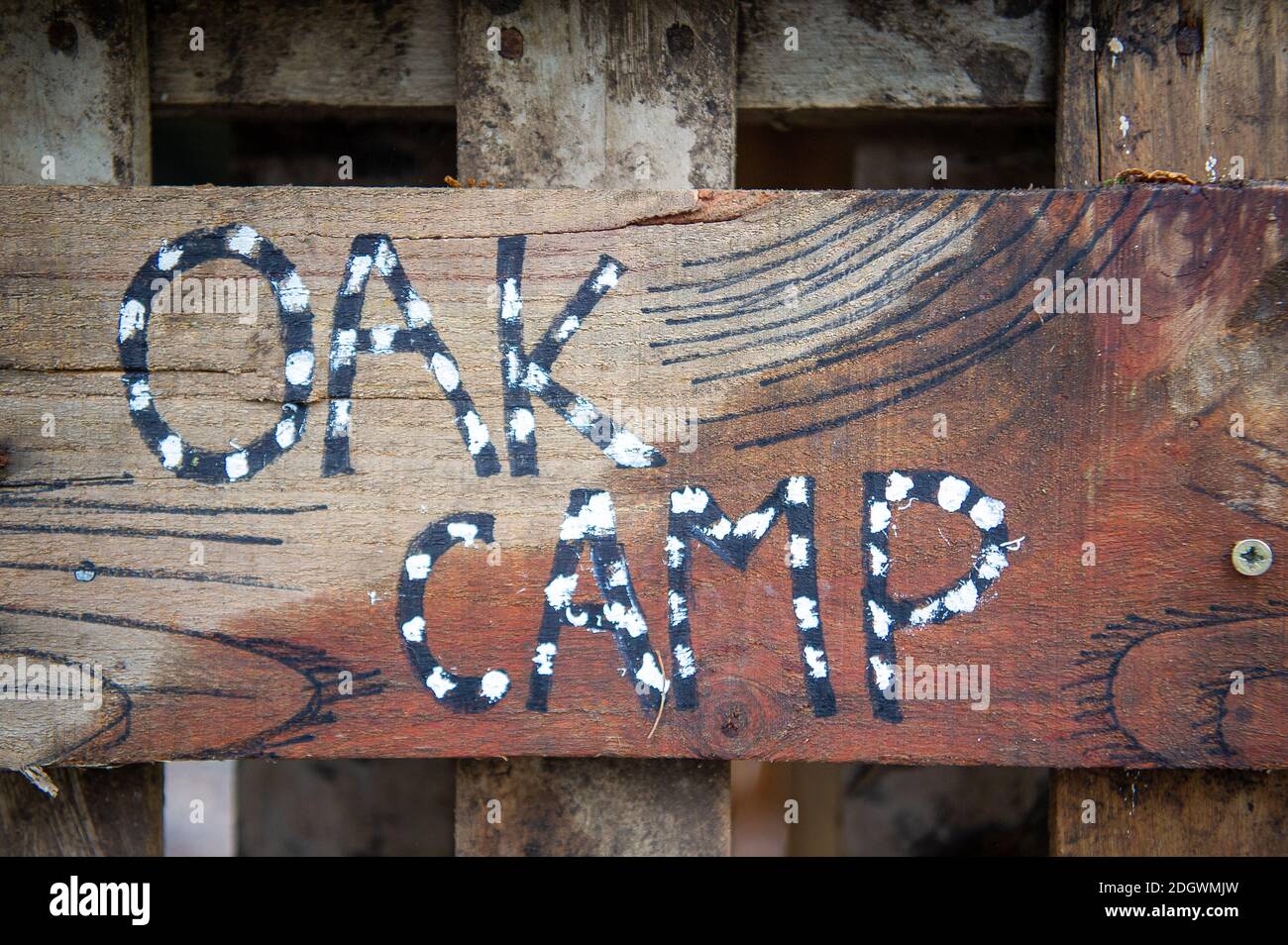 Denham, Buckinghamshire, UK. 9th December, 2020. An entrance sign to the protesters Oak Camp. HS2 Rebillion and environmental activists are living in tree houses there high in ancient trees next to the bridge trying to save them from the destructive chain saws of HS2 Ltd Stock Photo