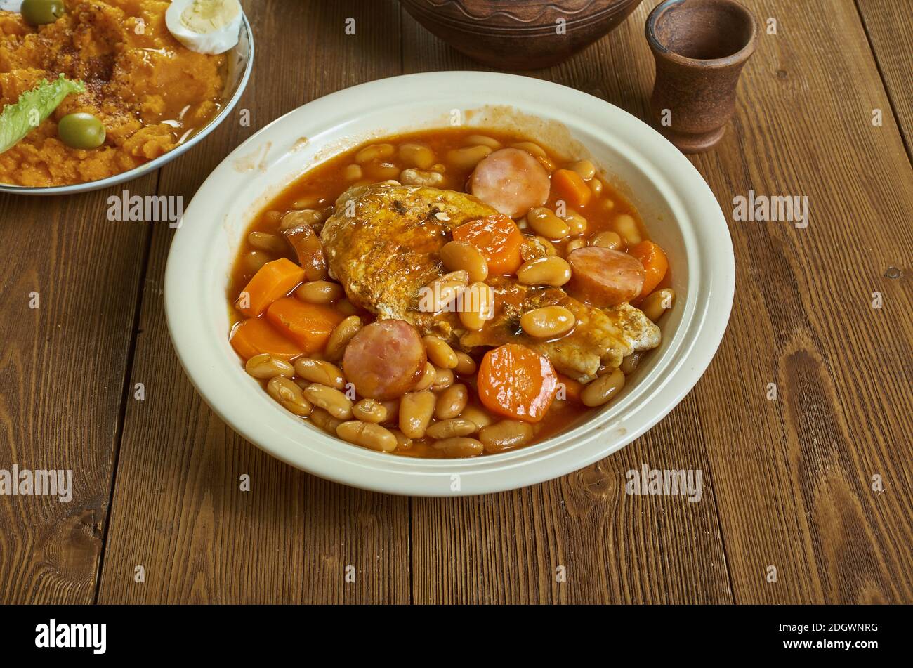 British pork cassoulet, filling pork dish with beans,pork sausages,  tomatoes and carrots Stock Photo