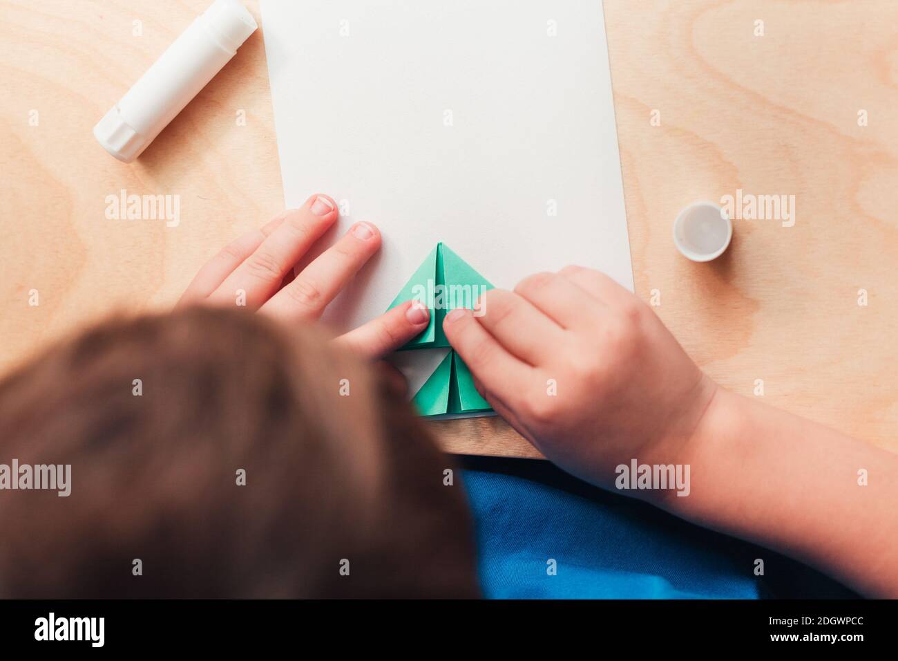 Step 5 of making Christmas card. Glue the prepared parts of the Christmas tree on the card sheet. Use imagination, for example, make Xmas tree upside down for this strange Christmas 2020 Stock Photo