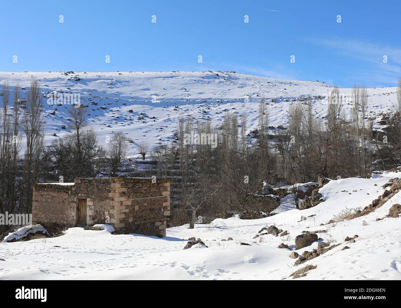 Snow  covered Mountain and Deserted Old House  in Nigde,Turkey Stock Photo