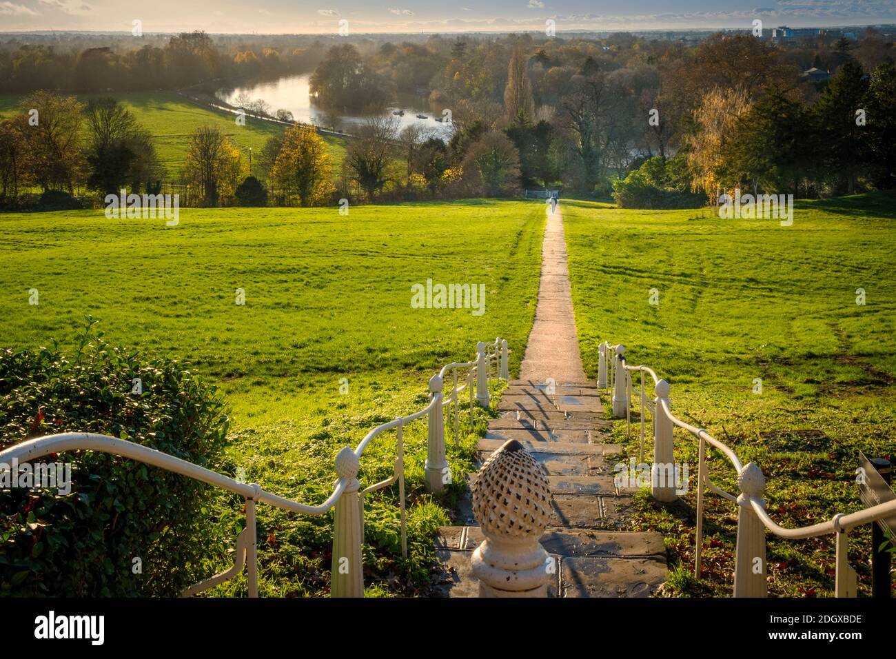 UK, London, walker on a path from Richmond Hill viewing point across Terrace Field towards the River Thames to Ham, Petersham & Twickenham. Autumn. Stock Photo