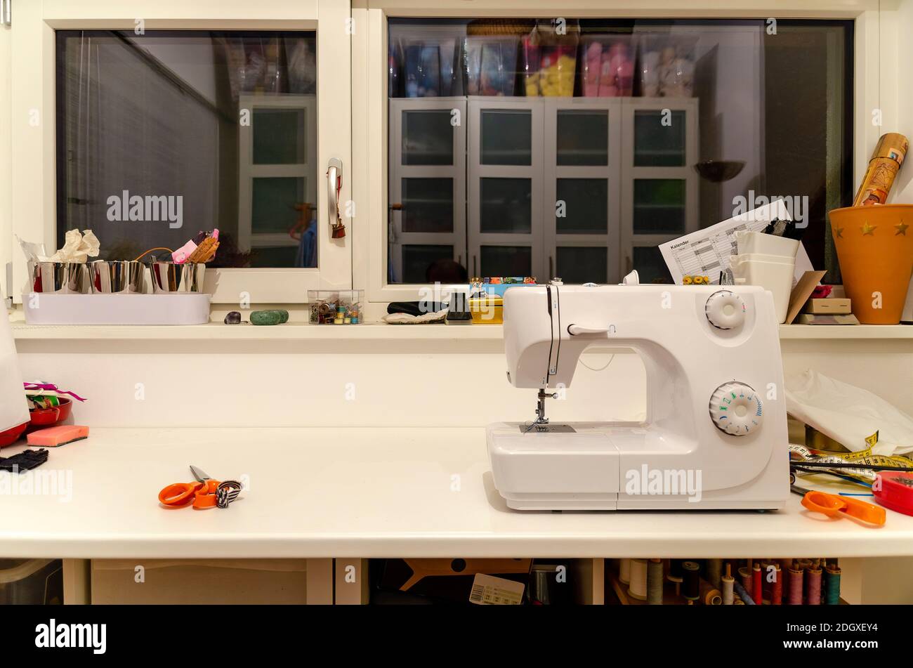 working table of a female dressmaker with sewing machine and some