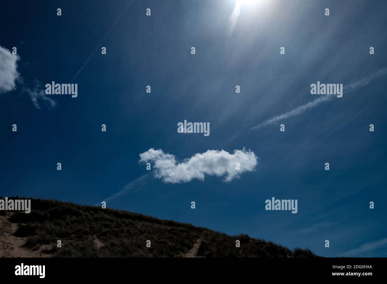 Defined single white cloud on a deep blue sky Stock Photo