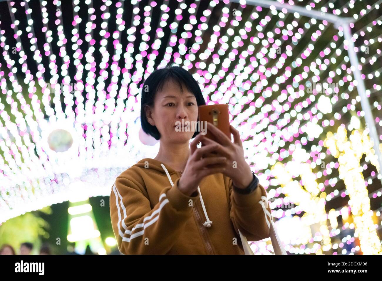 Woman using cellphone at night Stock Photo