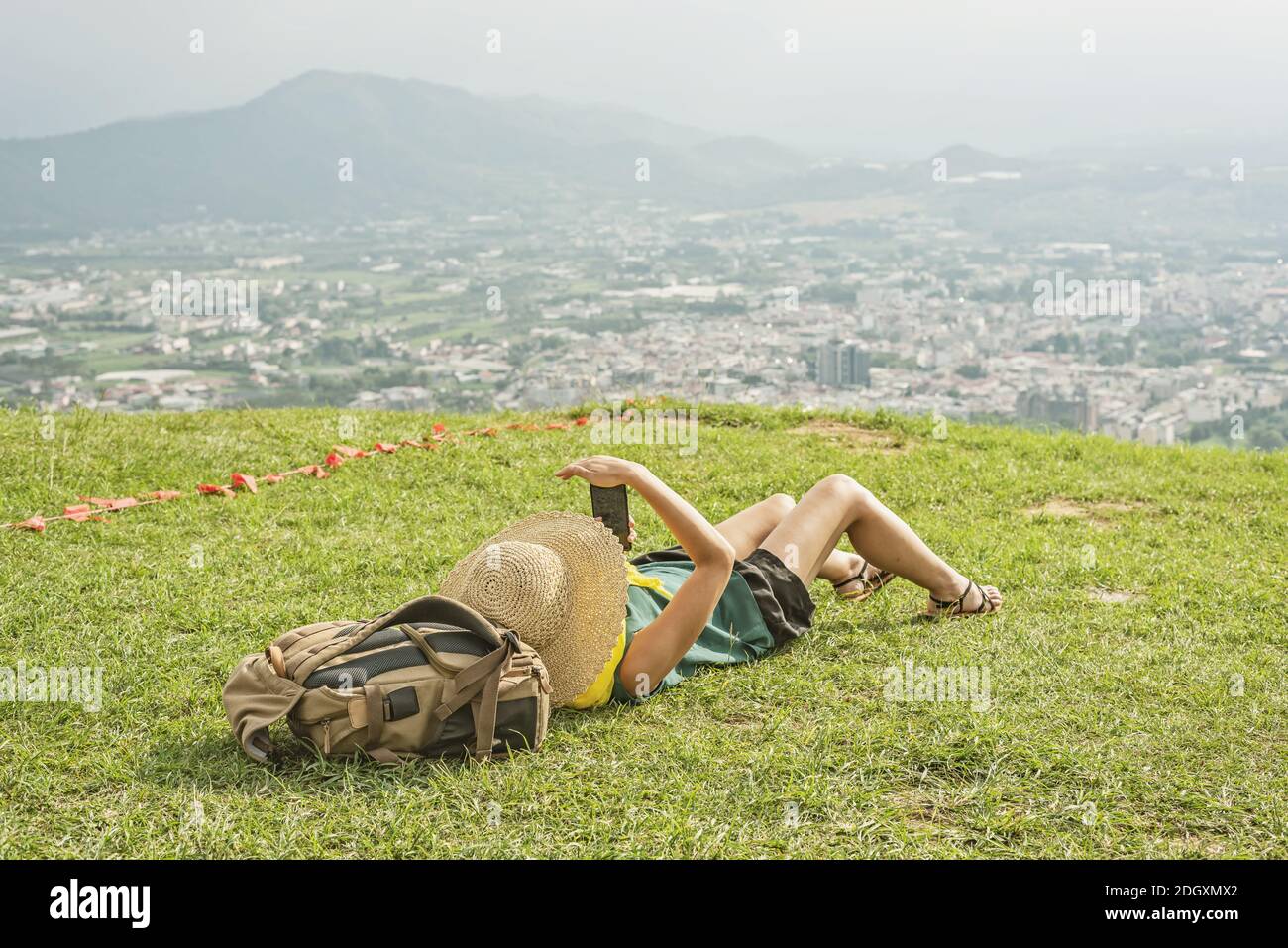 Woman lie on grassland and using cellphone Stock Photo