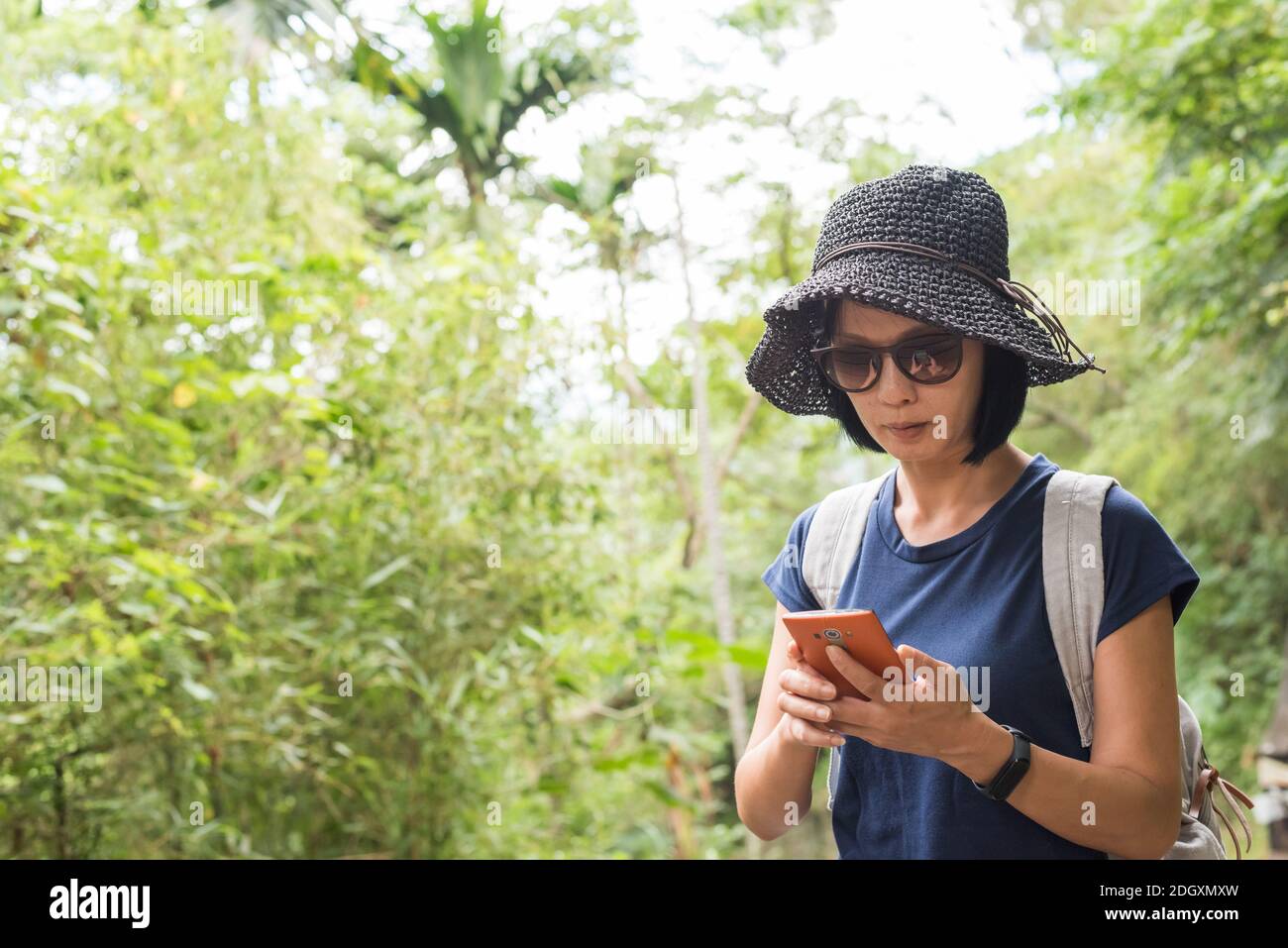 Using cellphone when hiking Stock Photo